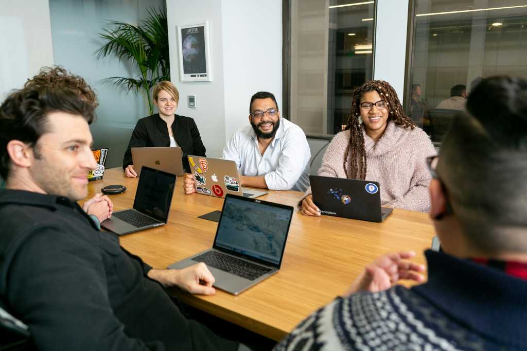 diverse group of tech pros in a meeting